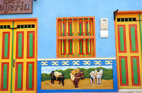 Front of a tipical house in Guatape Colombia featuring a colorful Zócalo illustration